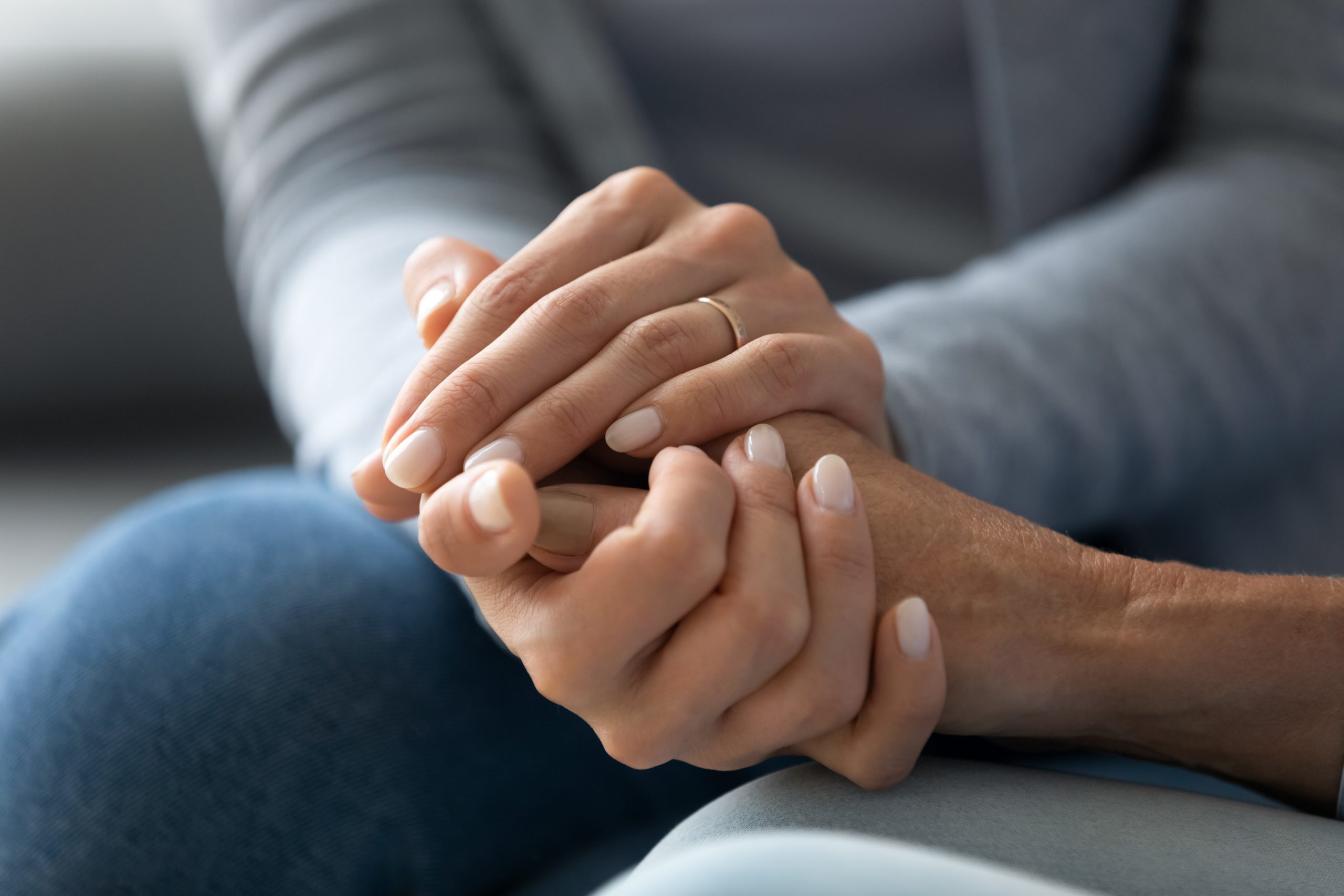 Hands held in a supportive conversation