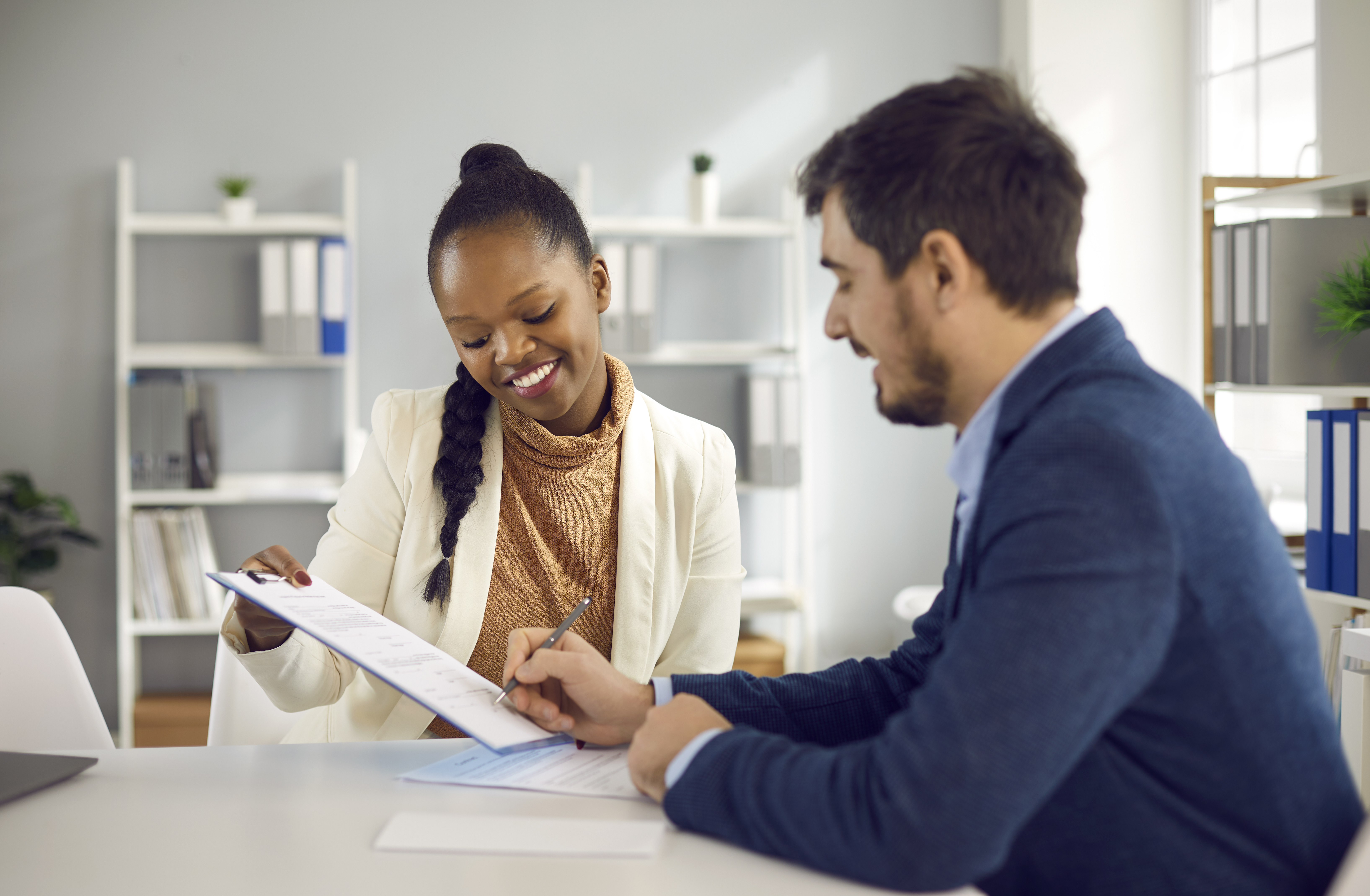 A person working through practical information with support