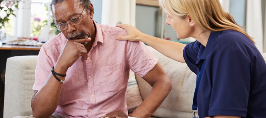 Support Worker Visits Senior Man Suffering With Depression