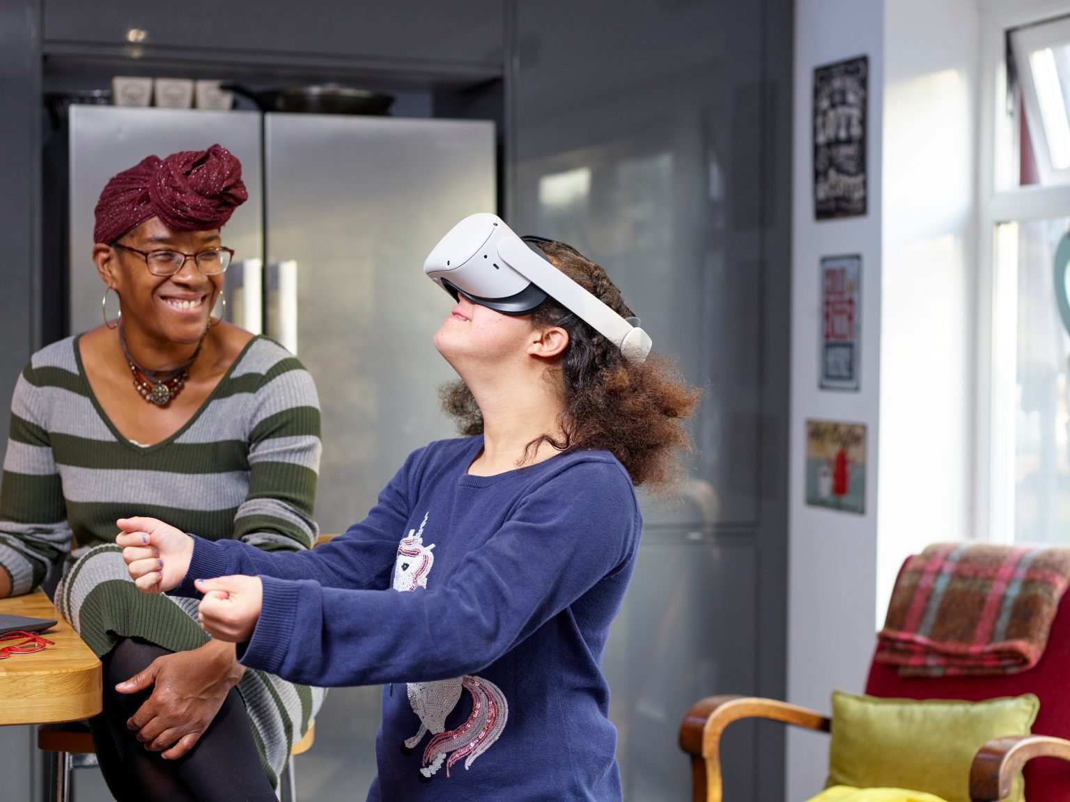 A woman supporting her daughter with an immersive activity