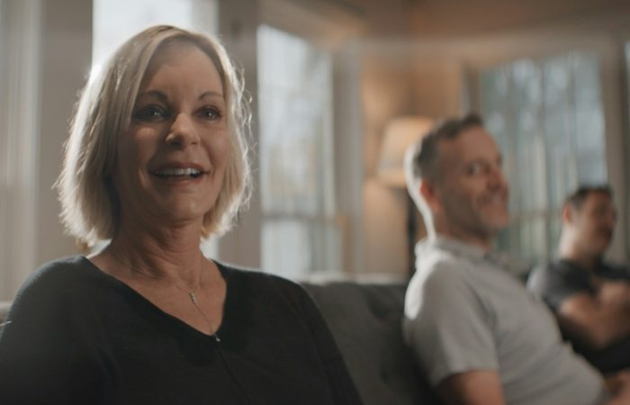 A woman takes part in a conversation in a bright living room