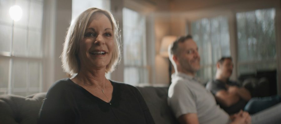 A woman takes part in a conversation in a bright living room