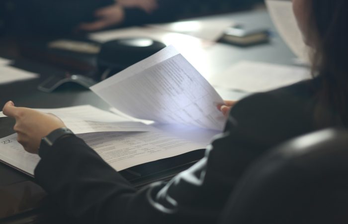 A woman reviews a document at a table