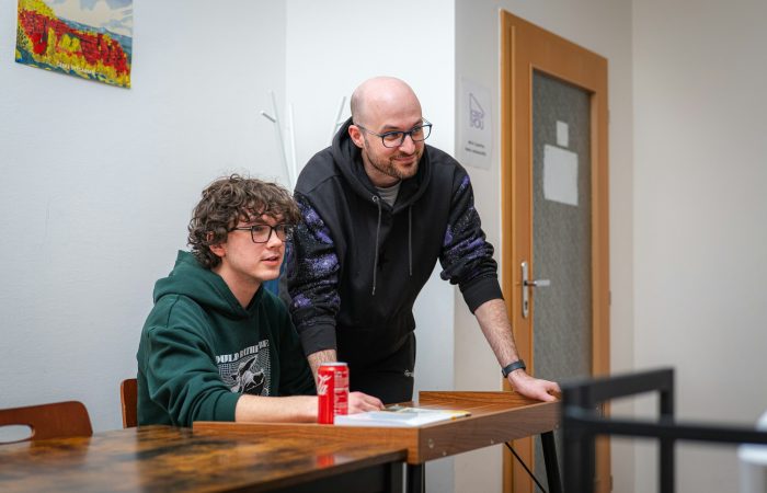 Two colleagues work together at a table