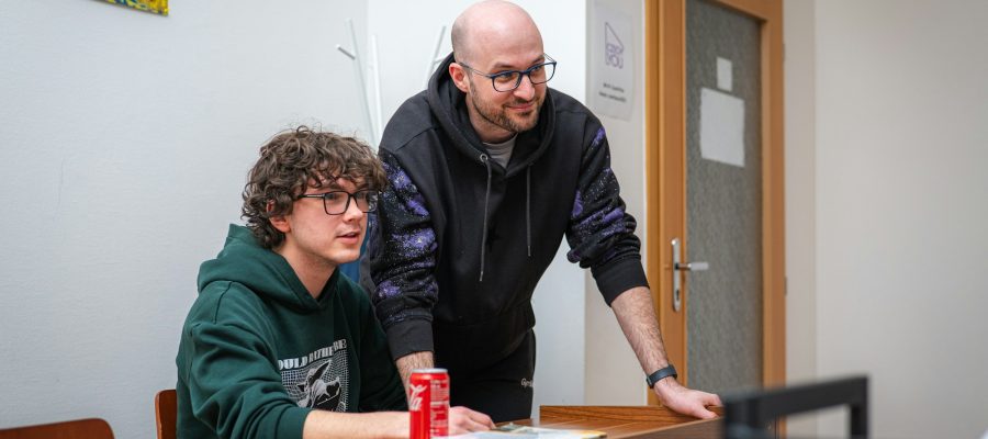 Two colleagues work together at a table